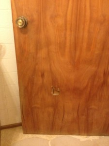 this ugly door features a hole - maybe someone really really REALLY had to go?
